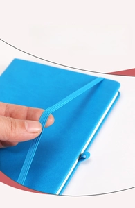 Detail showing the tension of the high-elastic bandage on a blue leather notebook