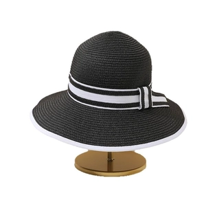 Chic black straw sun hat with elegant white ribbon bow and contrast edging decoration