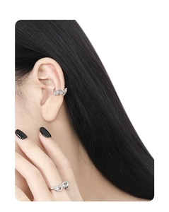 Detailed view of S925 silver ear cuff and matching ring with sparkling zircons on model
