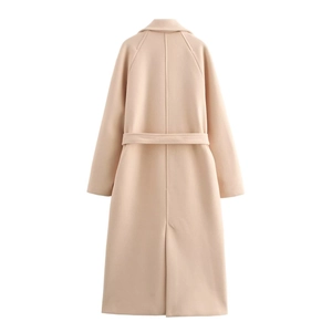 Detail view of the long beige wool coat back featuring a waist belt and back vent detail