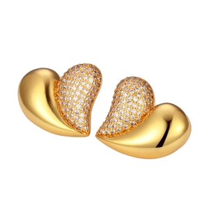 Elegant gold heart stud earrings with asymmetric polished metal and sparkling zircon stones