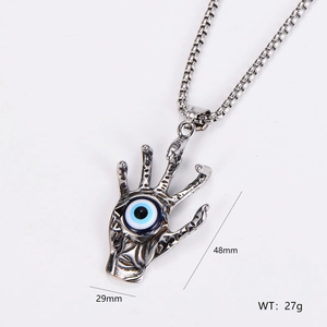 Detail view of silver palm pendant with blue eye and measurements 48mm x 29mm