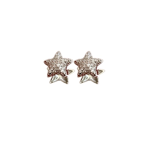 Minimalist silver star earrings with pavé zircon stones on white background