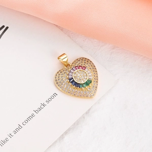 Detailed close-up of a heart-shaped gold pendant with colorful cubic zirconia stones