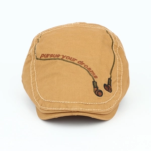 Close-up of khaki cotton beret featuring embroidered 'pursue your dreams' and headphones