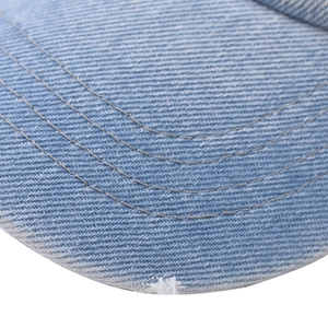 Detail of washed denim baseball cap featuring vintage distressed edges and triple stitching