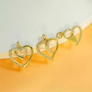Macro view of gold heart pendants with micro-pave zircons for DIY jewelry making