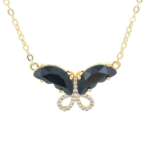 Elegant gold bow necklace featuring black faceted stones and sparkling white zircons