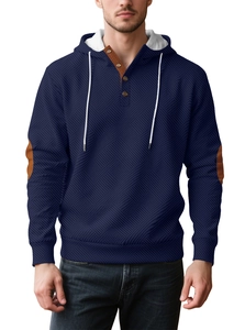 Detail of navy knit hoodie featuring brown button collar and textured fabric weave