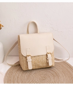 Detail of woven straw backpack with cream leather flap and double metal buckles