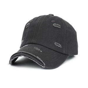 Detailed macro view of distressed cotton baseball cap with worn-out hole vintage effect