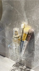 Wall-mounted bathroom organizer with transparent toothbrush holder and inverted mouthwash cup