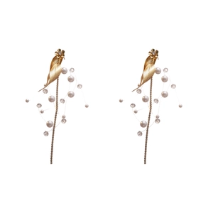 Vintage gold leaf earrings with pearl tassels and shimmering zircon crystals on white background
