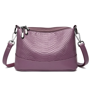 Elegant purple snake-embossed PU leather crossbody bag with adjustable straps on white background