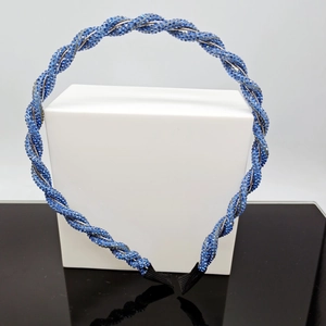 Detailed close-up of blue beaded headband on a twisted silver wire frame with black tips