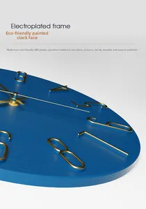 Detail of blue minimalist wall clock with 3D gold numbers and electroplated frame