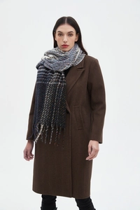 Detail shot of multi-color gradient scarf featuring tassels and classic plaid pattern