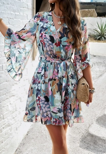 Close-up of floral print chiffon dress with V-neckline, tie waist and ruffled cuffs details