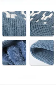 Detail of blue knit beanie showing fleece lining and intricate white wave textures