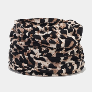Macro shot of seamless leopard print neck gaiter with soft knit texture and elastic fabric