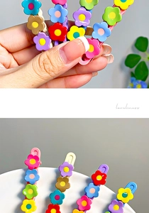 Macro detail of a colorful floral hairpin set with a vibrant rainbow resin flower design