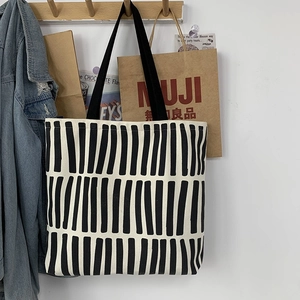 Detail shot of the minimalist striped canvas tote bag showing the thick fabric texture