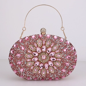 Detail of pink rhinestone evening bag with floral gemstone pattern and gold handle
