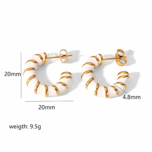 Detailed view of gold and white enamel hoop earrings with 20mm diameter and 9.5g weight