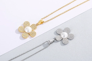 Detail showing gold and silver floral necklaces with crystal petals and central pearl