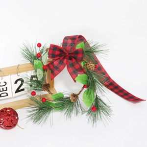 Christmas cabinet wreath with pine needles, red berries, pine cones and buffalo plaid bow