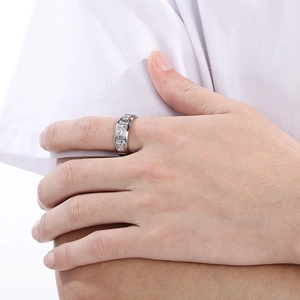 Close-up of 8mm silver titanium ring with pavé diamonds on a male model's finger