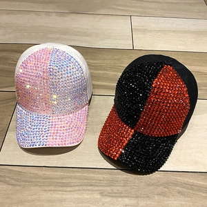 Sparkling handmade rhinestone baseball caps in black and white styles on wood surface