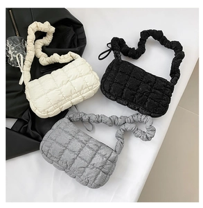 Three quilted shoulder bags in white, black and silver with stylish ruffled elastic straps