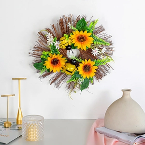 Decorative sunflower and bee wreath with yellow petals and green leaves on natural twigs