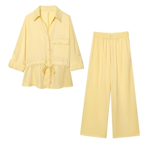 Pale yellow two-piece set featuring drawstring waist shirt and wide-leg trousers in detail