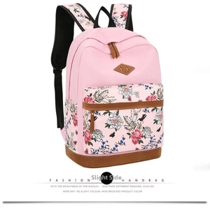 Detail view of the floral print pattern and brown suede accents on the pink backpack