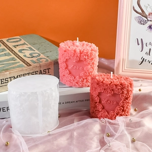 DIY rose heart silicone mold with Love relief and finished candles on pink mesh cloth