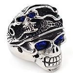 Close-up of gothic skull ring with blue gemstone eyes and vintage embossed details