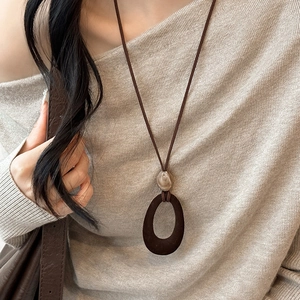Retro velvet resin oval pendant necklace with beige beads on a long cord sweater chain