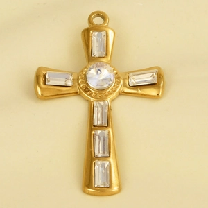 Close-up of a gold stainless steel cross pendant with inlaid crystals on beige background