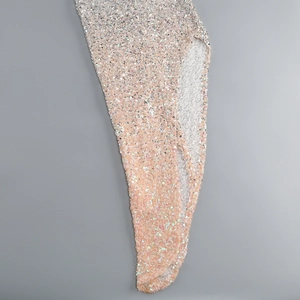 Close-up of high-density gradient silver sequins with side slit detail on dress