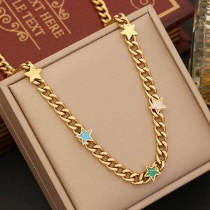 Golden stainless steel necklace featuring colorful star pendants on a beige jewelry box