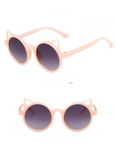 Detail of pink cat-ear sunglasses with gray gradient lenses for kids and stylish children