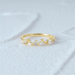 Macro shot of S925 sterling silver stamp on golden leaf ring with marquise cut zircon