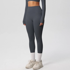 Detail view of high waisted dark gray blue yoga pants with functional side pockets