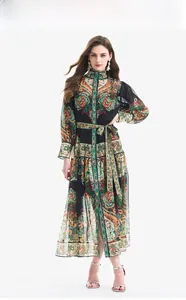 Detail of vintage paisley print dress featuring lantern sleeves and a belted waistline