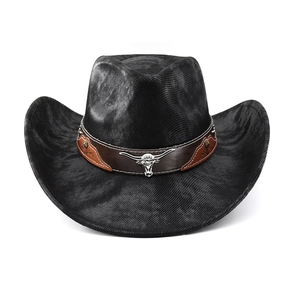Detail of western hat with silver bull head emblem and vintage studs on brown leather band