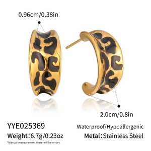 Detail view of gold C-shaped earrings with leopard enamel pattern and dimensions