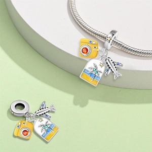 Detail of travel charms featuring a yellow camera, silver airplane, and beach landscape pendant