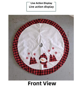 Close-up of a Christmas tree skirt with buffalo plaid edges and snowman embroidery detail